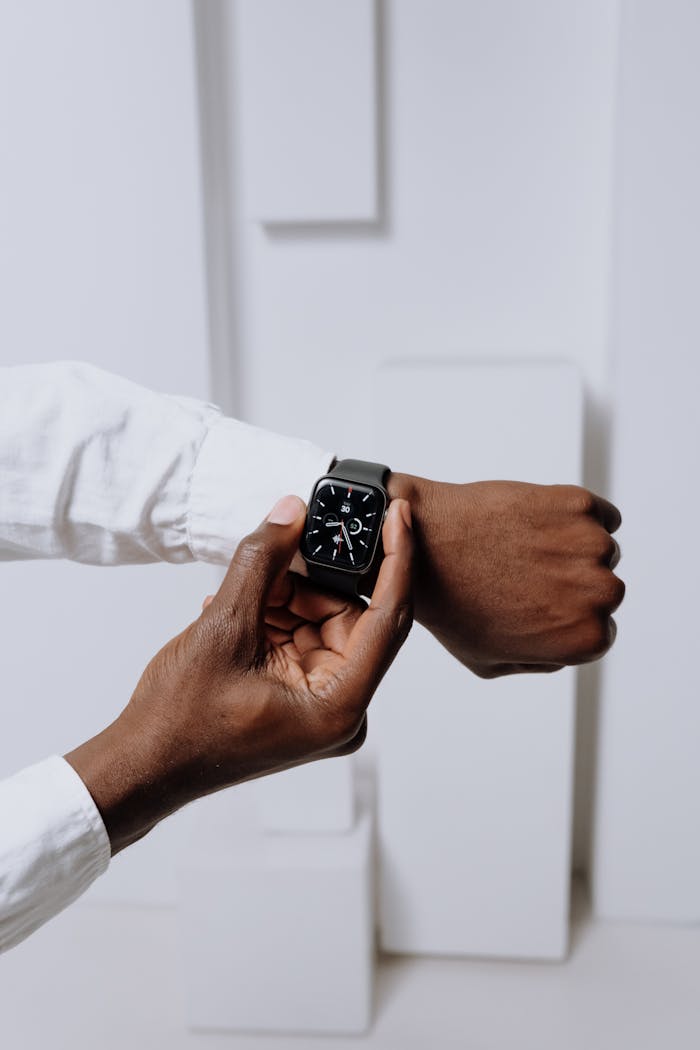 team-04 Close-up of a smartwatch on a person's wrist, highlighting modern technology with a minimalist aesthetic.